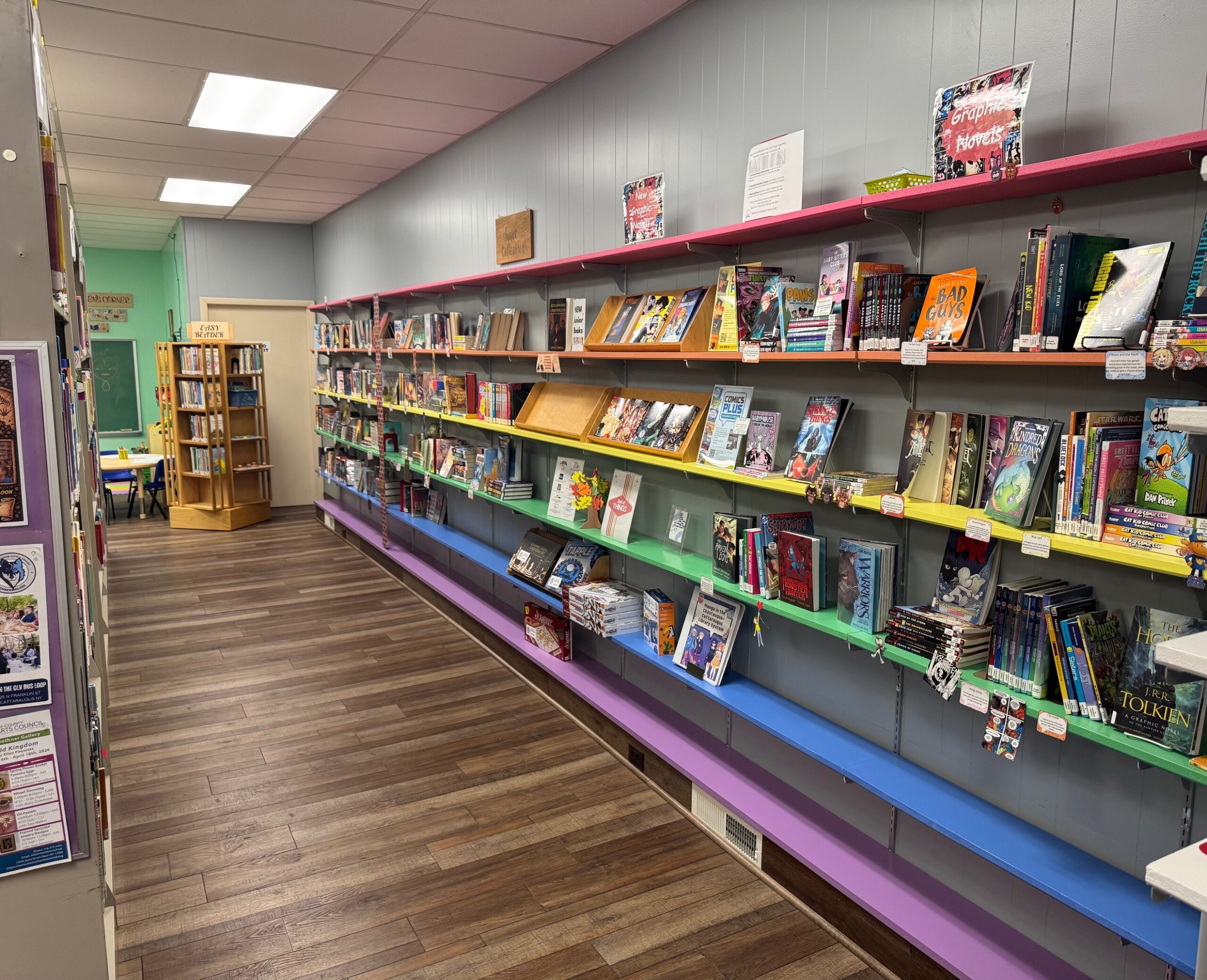 Library photo of the young reader's section with rainbow colored shelving.